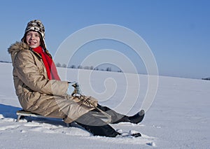 Teen girl sledding from a hill