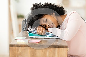 Teen Girl Sleeping During Class Resting Head On Books Indoors