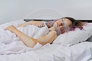 Teen girl sleeping at home in bed
