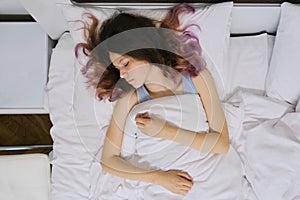 Teen girl sleeping at home in bed, view from above