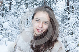 Teen girl in a snowy forest