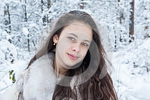 Teen girl in a snowy forest