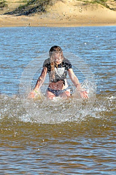 Teen girl splashing in water