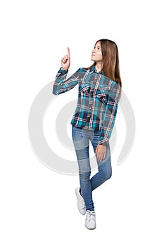 Teen girl standing casually pointing up