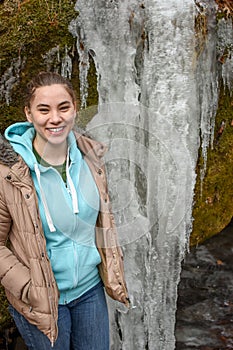 Teen girl standing by frozen waterfall - Governor Dodge State Park - Wisconsin