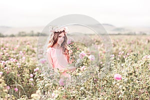 Teen girl standing in rose garden