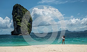 Teen girl standing on tropical beach in Thailand