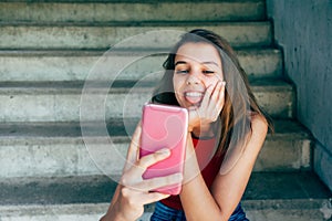 Teen girl sticking out tonge for a selfie