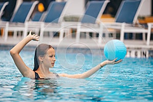 Teen girl swimming in pool