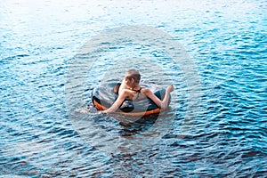 Teen girl swimming using a swim tube