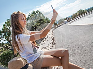 Teen girl taking selfie with phone