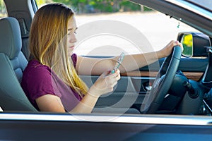 Teen girl texting and driving photo