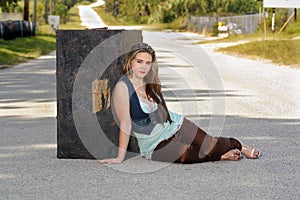 Teen Girl with a Trunk in the Street