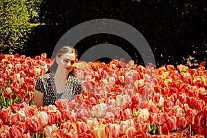 Teen Girl in Tulip Flower Garden