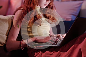 Teen Girl Typing On Laptop In Evening