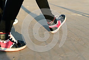 Teen girl walking with pink sneakers
