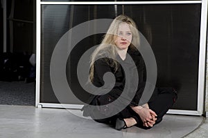 Teen girl wearing Gothic clothes sitting on the fl