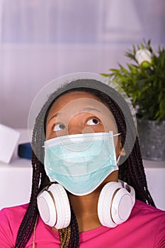 Teen girl wearing a mask looking upwards