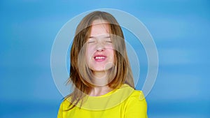 Teen girl in a yellow t-shirt is looking to the camera, nods her head and says yes