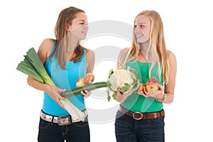 Teen girlfriends with fresh vegetables and fruit