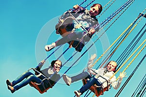 Teen girls on the chain swing carousel