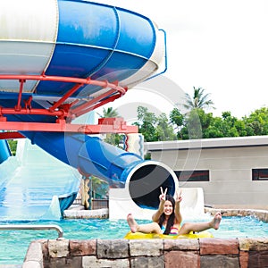 Teen girls having fun with big sliders in aqua park