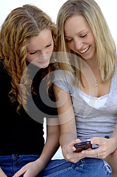 Teen girls sending text message photo