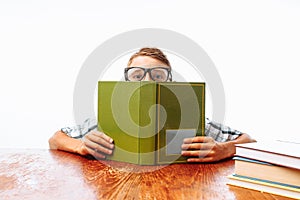 Teen guy fell asleep sitting with books, student sleeping at Desk in Studio on white background