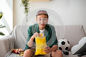 Teen guy football fan watching football game