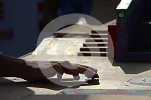 teen hand playing the fingerboard. freestyle and hurdles. Finger skateboard fingerboard mini skate, selective focus. home games in