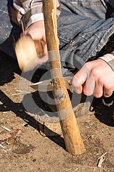 Teen hand splitting wood