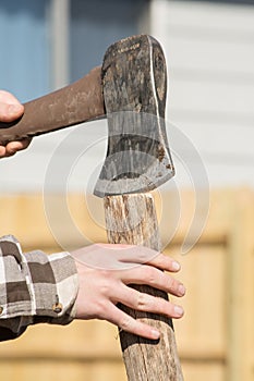 Teen hand splitting wood