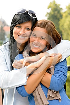 Teen and her mother embracing outdoors bonding