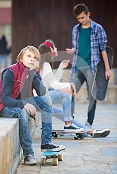 teen and his friends after conflict outdoors