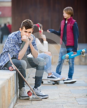 teen and his friends after conflict outdoors