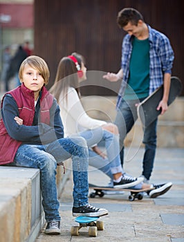 Teen and his friends after conflict outdoors