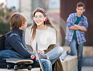 Teen and his friends after conflict outdoors