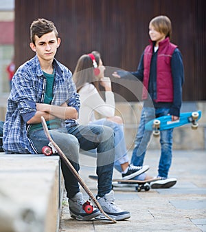 Teen and his friends after conflict outdoors