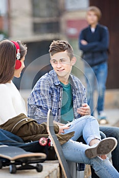 Teen and his friends after conflict outdoors