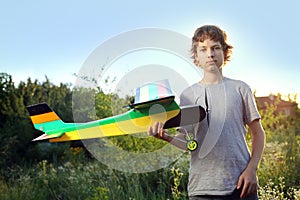 Teen with homemade radio-controlled model aircraft