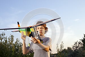 Teen with homemade radio-controlled model aircraft