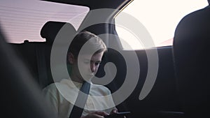 Teen inside the car playing on the smartphone