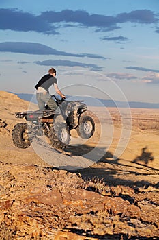 Teen jumping on quad ATV