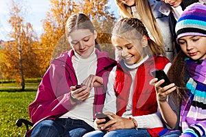 Teen kids busy with cell phones