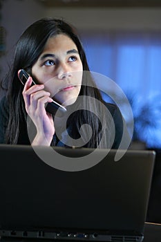Teen on laptop and cell phone