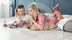 Teen leisure girls hanging out floor home drawing