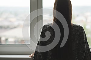 Teen loneliness,teenager has depression,a young girl is unhappy,upset, looks out the window