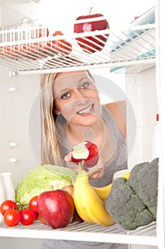 Teen looking at food in fridge