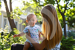 Teen nanny with cute baby outdoors on  day
