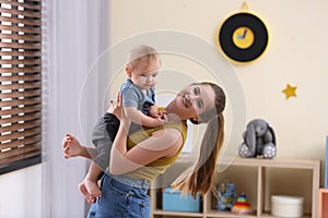 Teen nanny playing with cute little baby